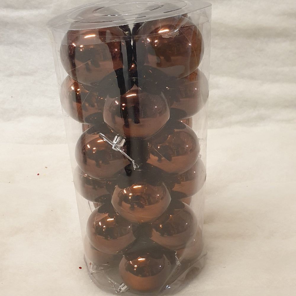 Tube of shiny copper baubles