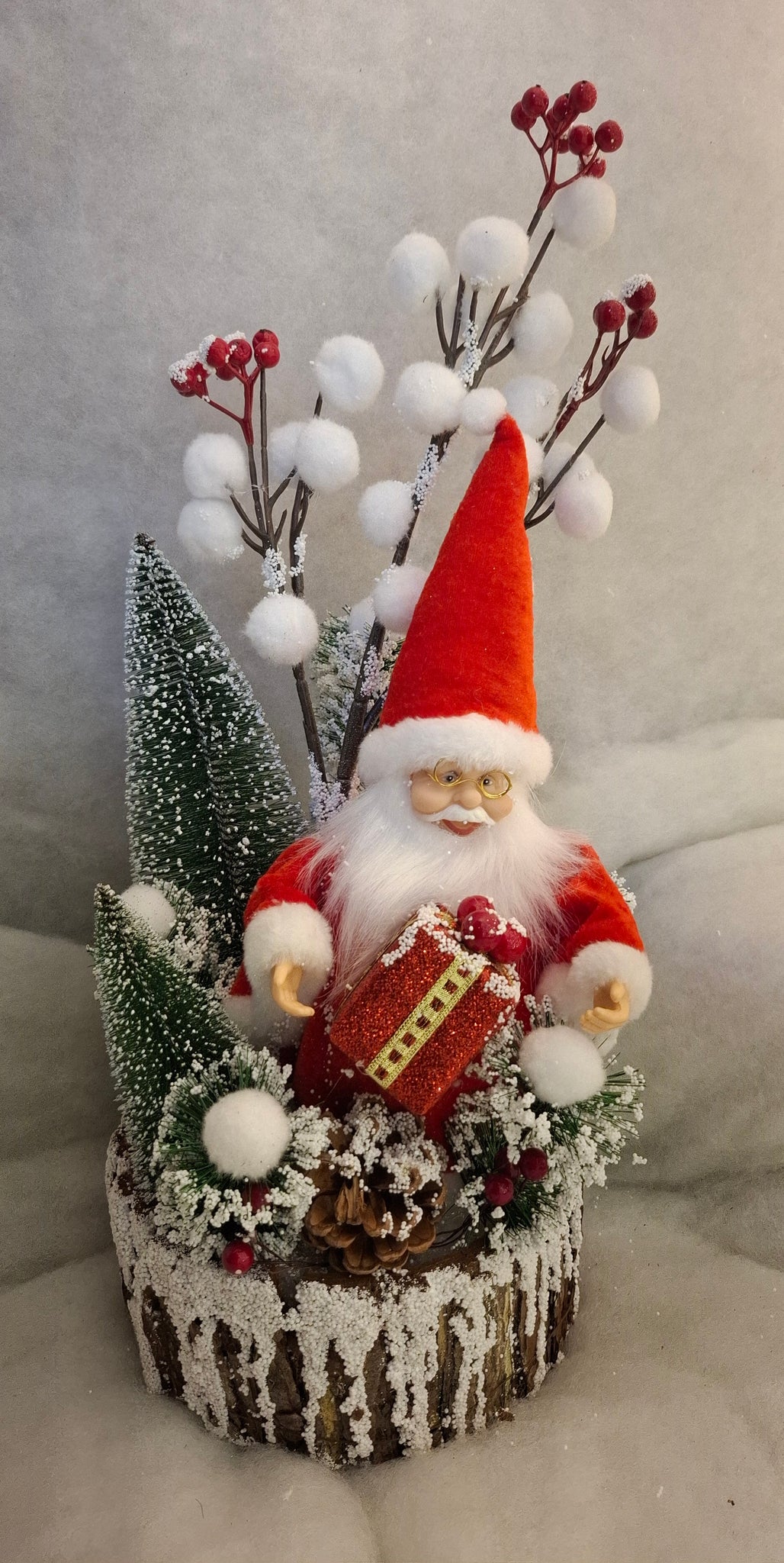 Santa Holding Gift in a Snowy Berry and Pinecone Pot Decoration