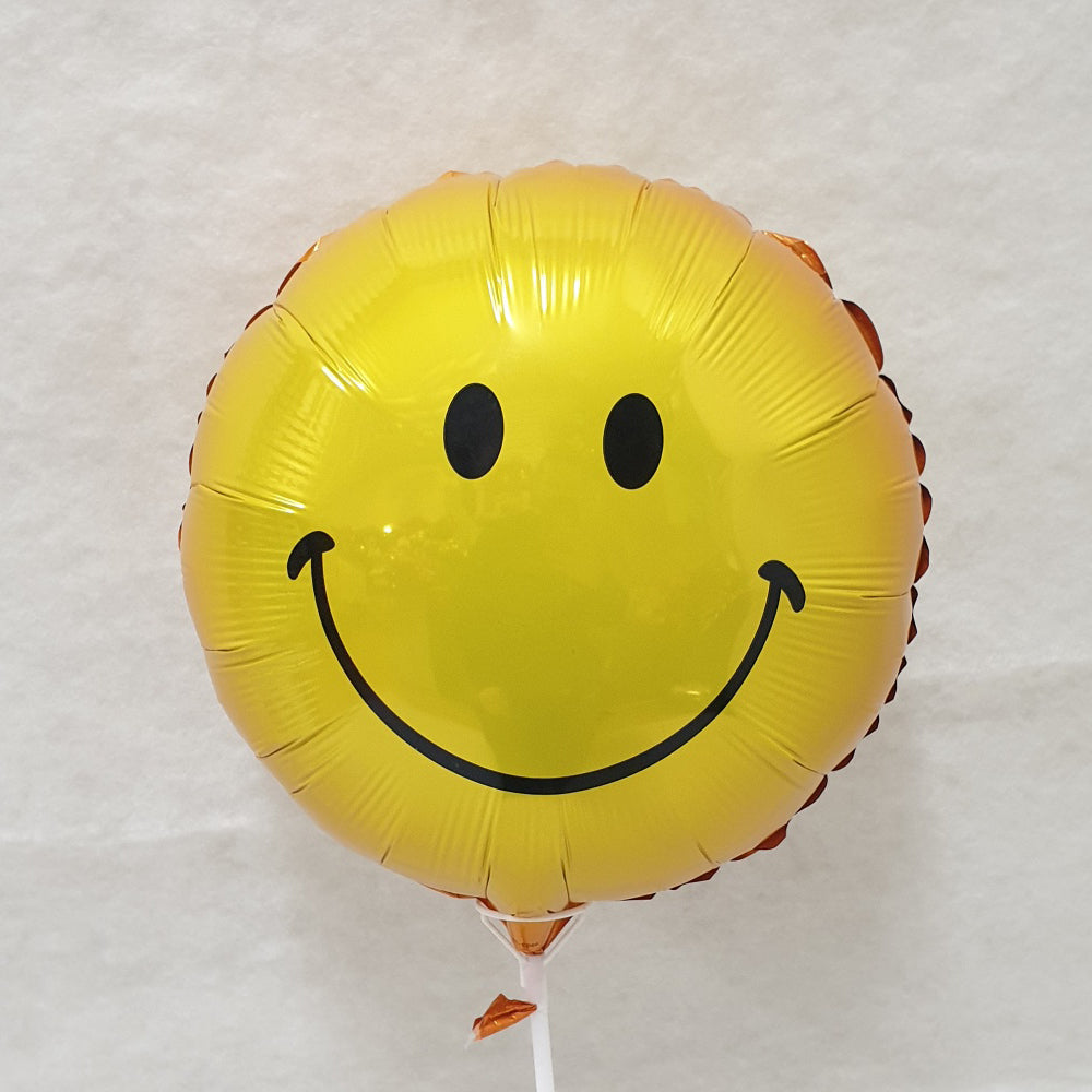 Yellow smiley face balloon - uninflated